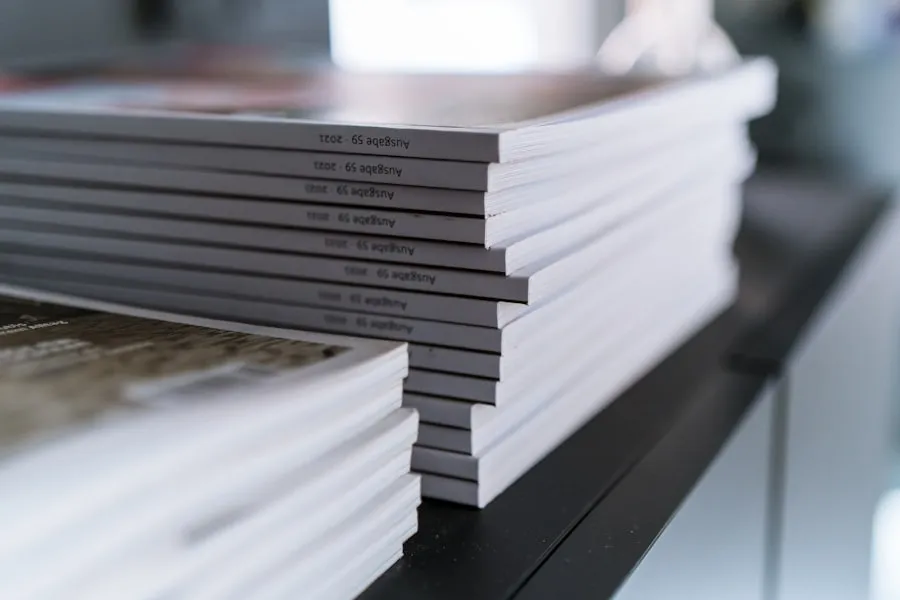 A stack of printed brochures on a shelf