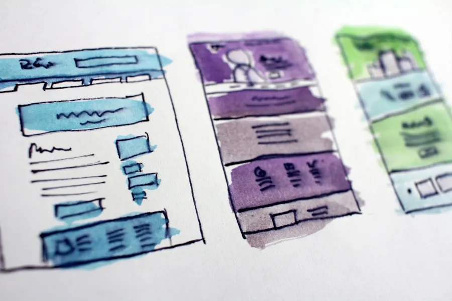Hand-drawn page wireframes sketched on paper
